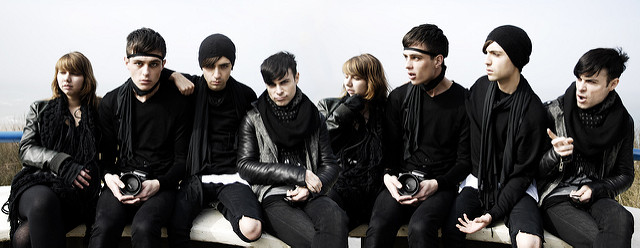 Image 7: A group of people wearing similar black clothing.